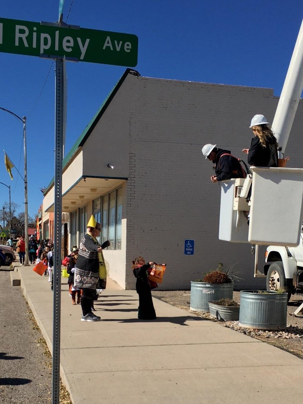 Coop Employees giving out candy in bucket truck